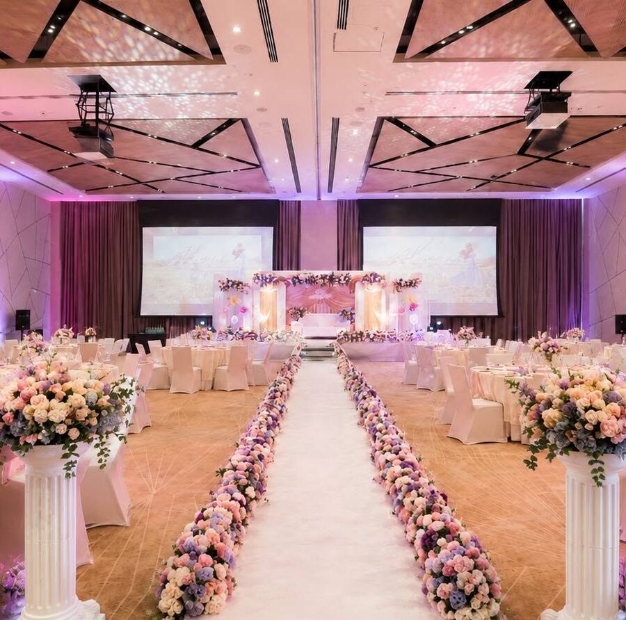 Floral-lined aisle and ballroom reception setup for a full-service wedding event in Abu Dhabi